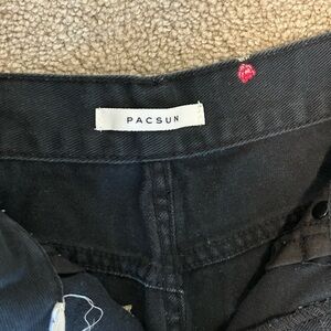 Black high-waisted mom jeans with pink rose embroidery. Lightly worn.